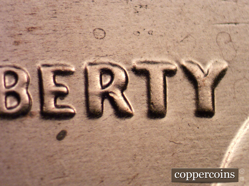 Die-stage C marker on 2021P•1DO•003 showing Etra thickness on ERTY in LIBERTY.