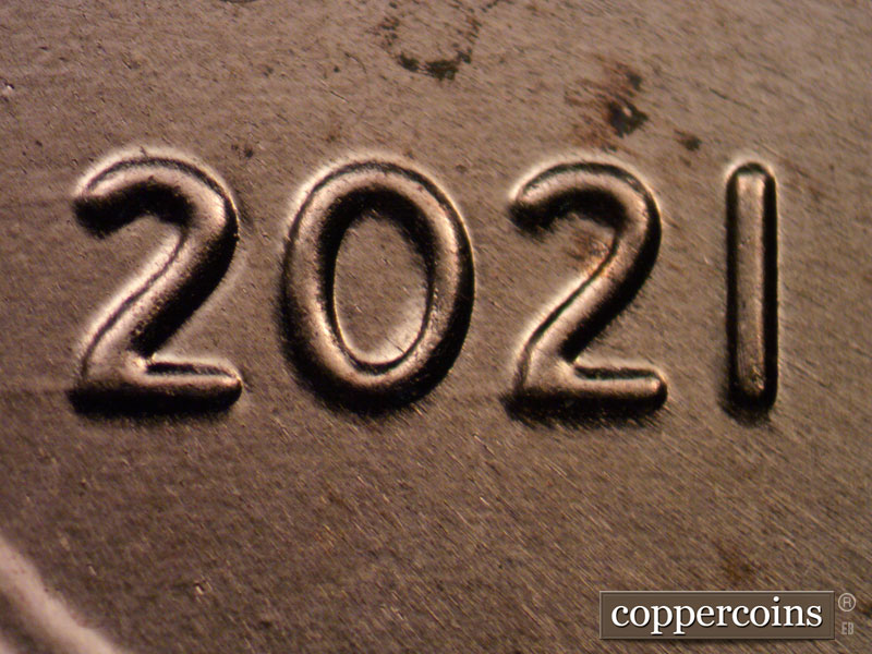 Die-stage C marker on 2021P•1DO•003 showing Extra thickness on 20 in date.