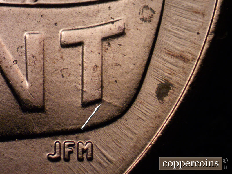 Die-stage C marker on 2021P•1DO•003 showing Die crack though bottom of T in CENT.