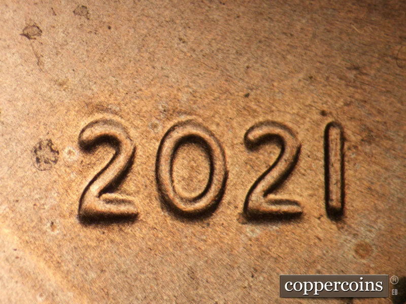 Die-stage B marker on 2021P•1DO•005 showing Extra thickness on 20 in date.