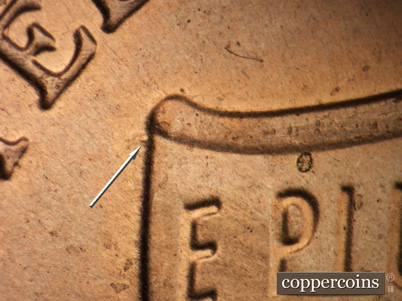 Die-stage A marker on 2021P•1DO•006 showing Die dot just to the left of upper shield.