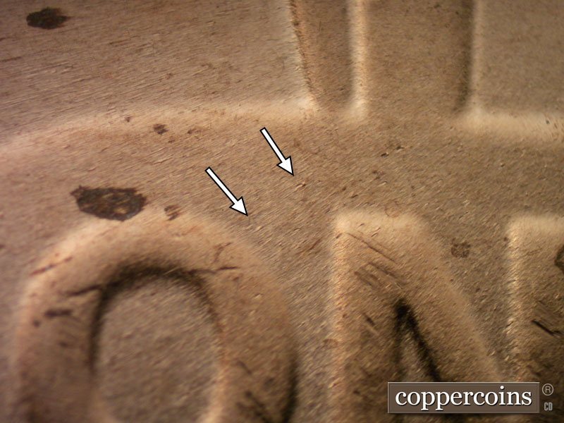 Die-stage B marker on 2023D•1DR•001 showing Small die blemishes near O in ONE.