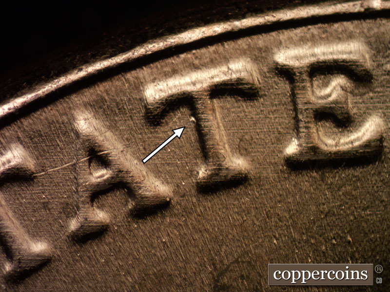Die-stage C marker on 2023D•1DR•002 showing Die dot near scond T in STATES.