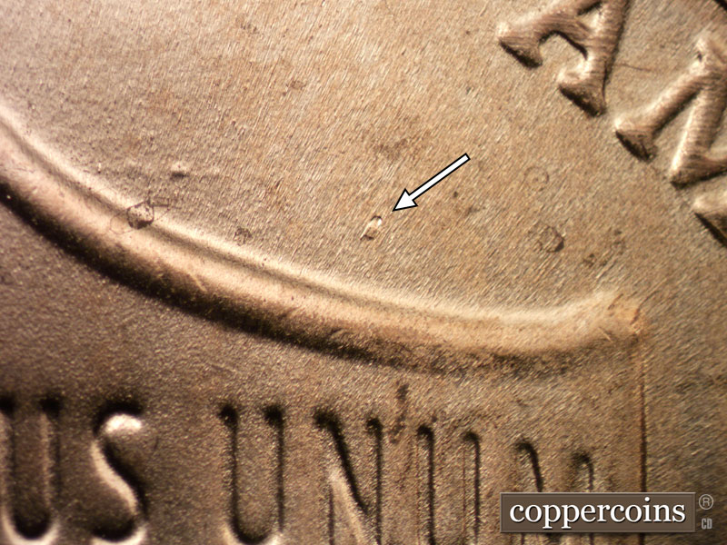Die-stage C marker on 2023D•1DR•002 showing Die gouge in field above right side of shield.
