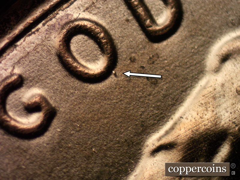 Die-stage B marker on 2024D•1DO•001 showing A die dot shows on the bottom right of the O of GOD.