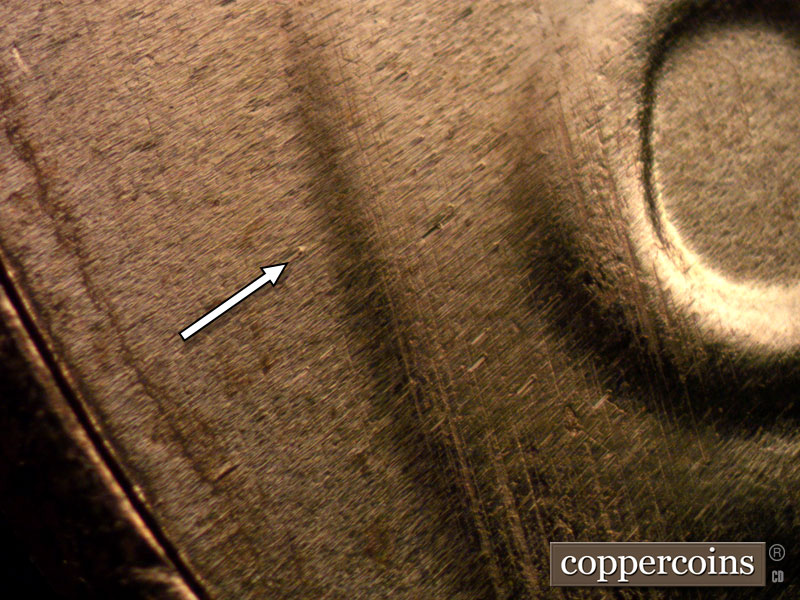 Die-stage B marker on 2024D•1DO•001 showing Die dot in field right of shield.