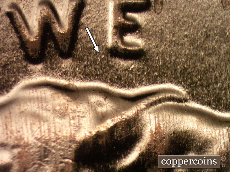 Die-stage B marker on 2024D•1DR•001 showing Die dot near bottom of E in WE.