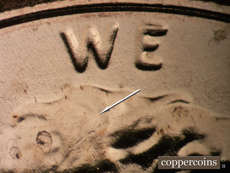 Die-stage B marker on 2024P•1DO•001 showing Doubling shows on WE, SSE die gouge under W in WE in hair.