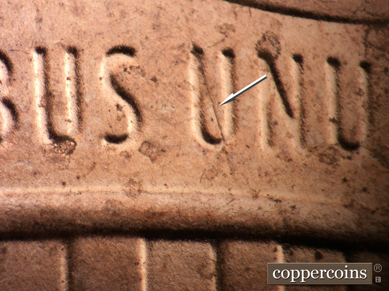 Die-stage C marker on 2024P•1DO•001 showing Die gouge or crack through first U in UNUM.