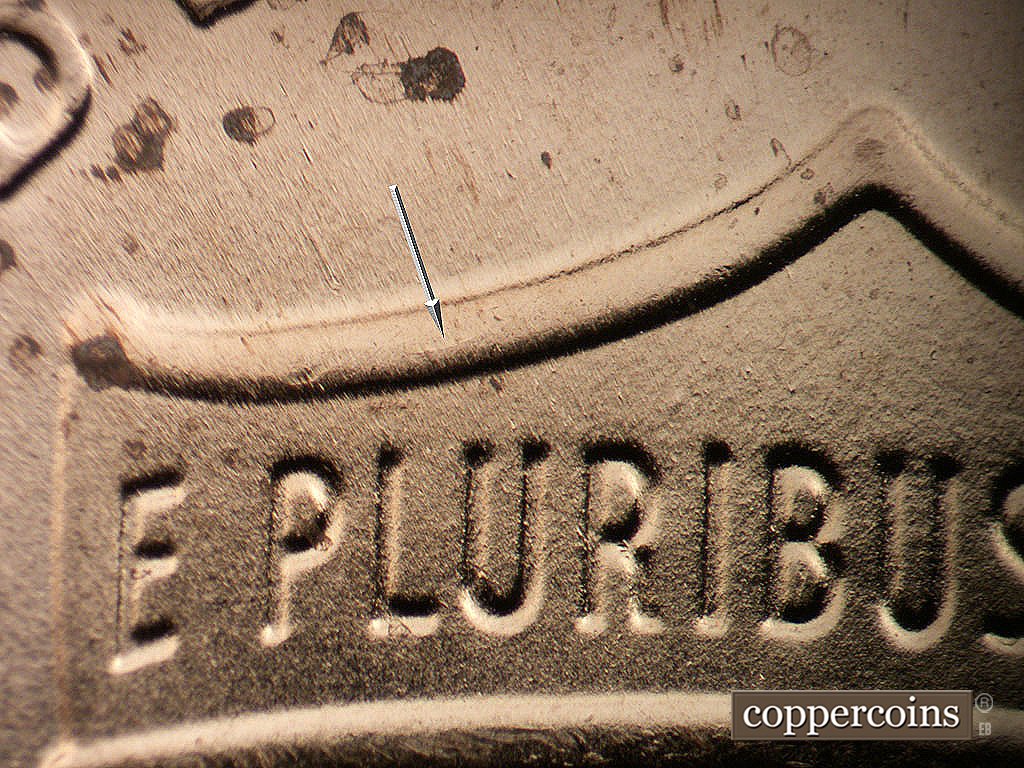 Die-stage B marker on 2024P•1DR•001 showing Die crack on upper left hield.