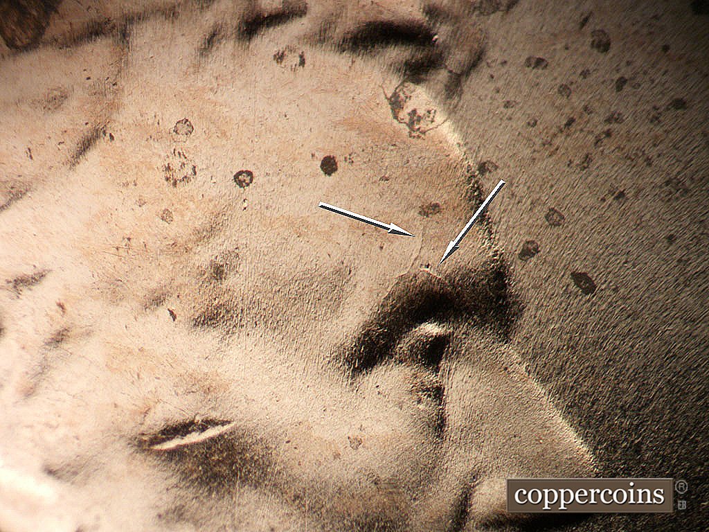 Die-stage B marker on 2024P•1DR•001 showing DIe crack on eyebrow and forehead.