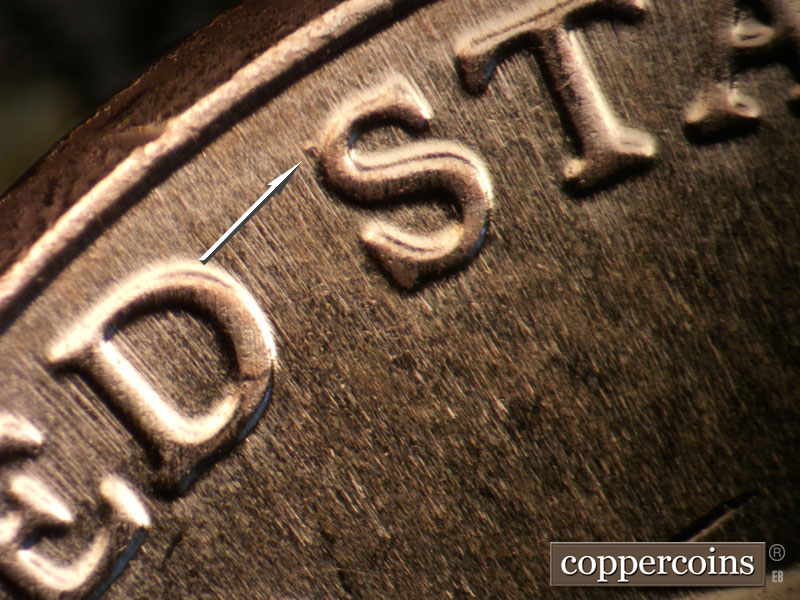 Die-stage B marker on 2025P•1DO•001 showing Small die gouge on first S in STATES.