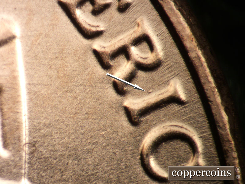 Die-stage B marker on 2025P•1DO•001 showing Small die gouge near I in AMERICA.