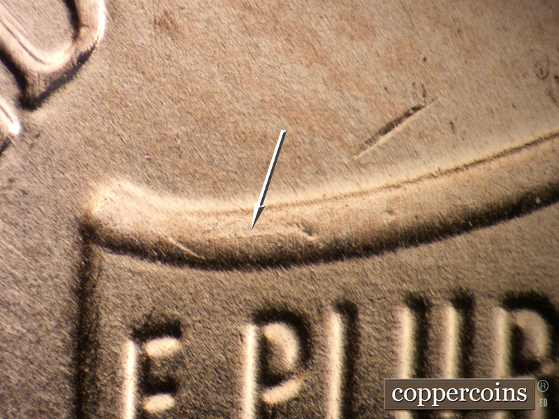 Die-stage B marker on 2025P•1DO•001 showing Die crack forming on left top of shield.