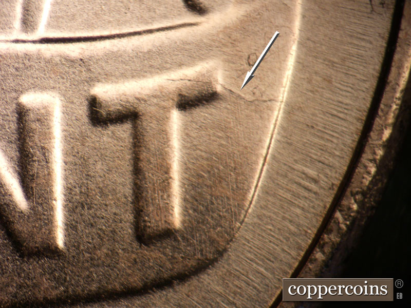 Die-stage B marker on 2025P•1DO•001 showing Die crack through top of T in CENT.