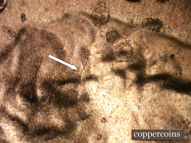Die-stage B marker on 2025P•1DO•002 showing Die crack in hair.