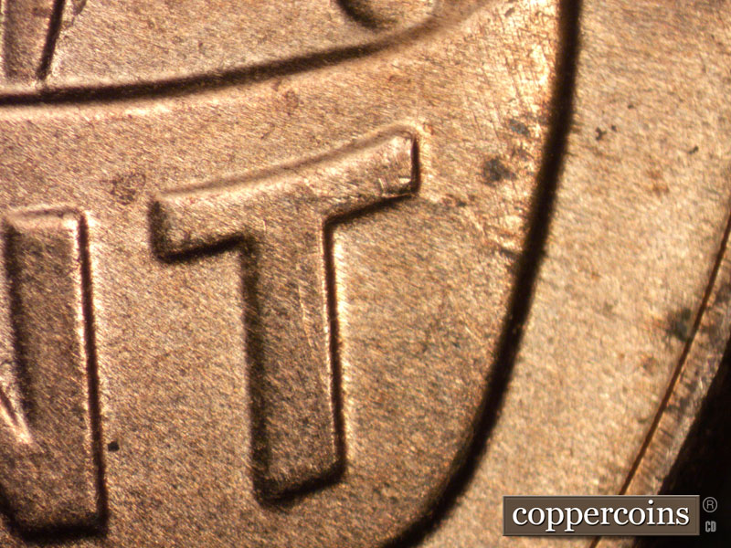 Die-stage B marker on 2025P•1DO•002 showing Die crack from top of T in CENT.