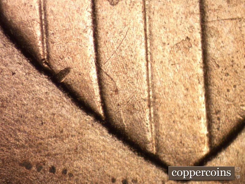 Die-stage B marker on 2025P•1DO•002 showing Die crack in lower shield.