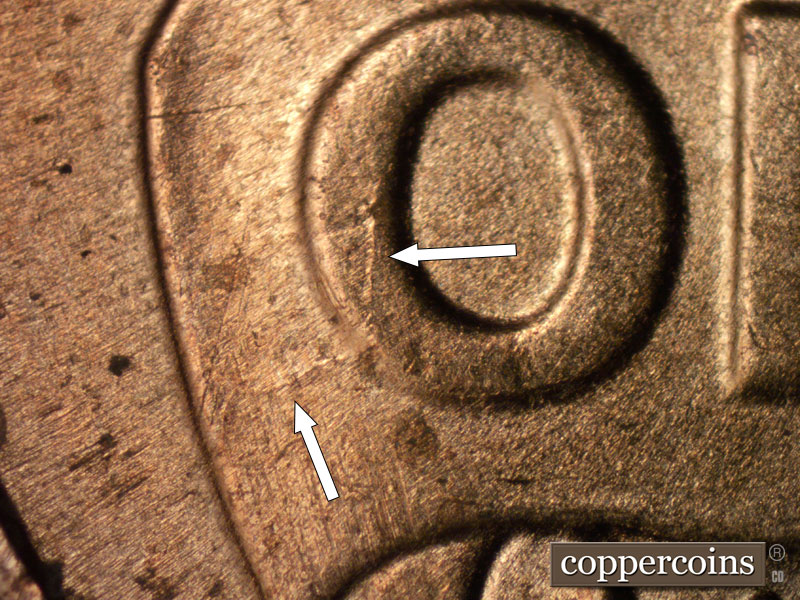 Die-stage B marker on 2025P•1DO•002 showing Die crack on O in ONE.