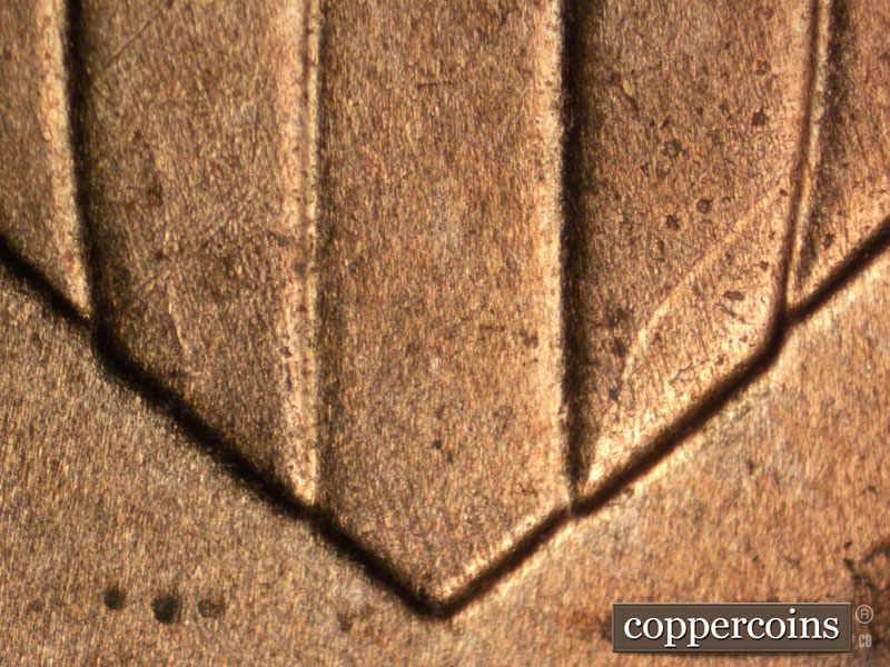 Die-stage B marker on 2025P•1DO•002 showing Die crack in lower shield.
